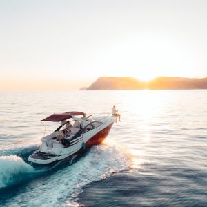 Yacht riding on a beach with a sunset