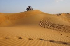 Vehicle on sand dune in the desert in Dubai