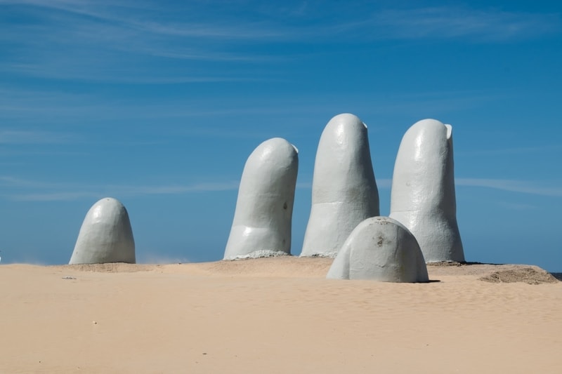 Hand in the sand art sculpture in Puta del Este, Uruguay