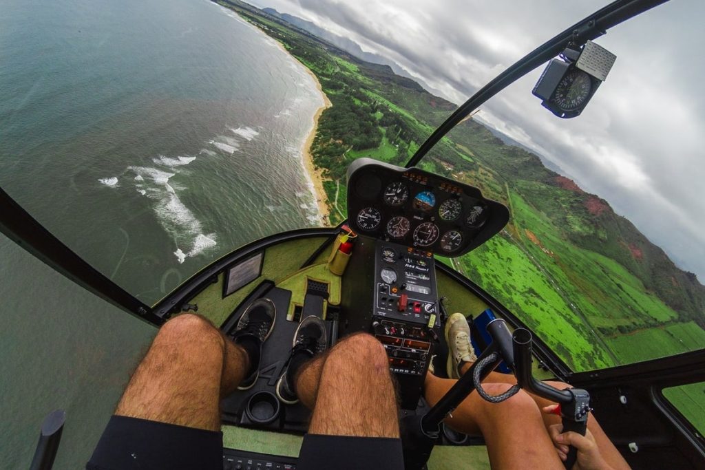 Two people riding a helicopter in Kauai