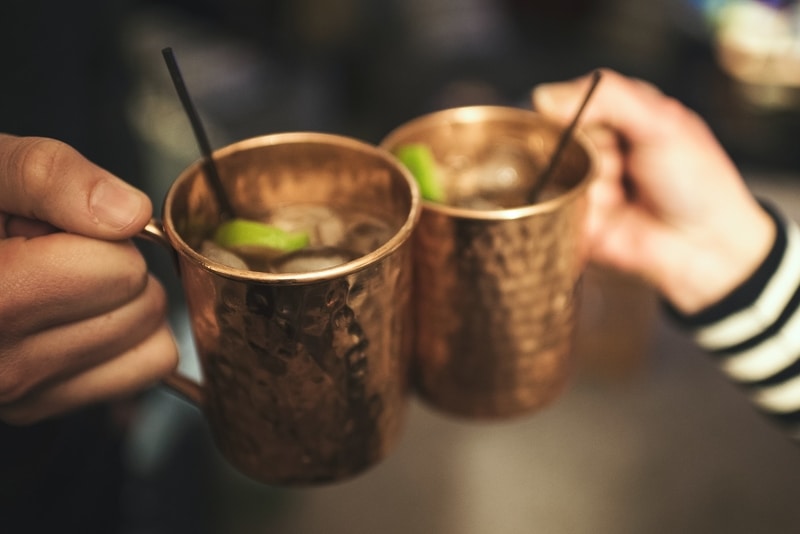 Two Moscow mules in copper mugs.