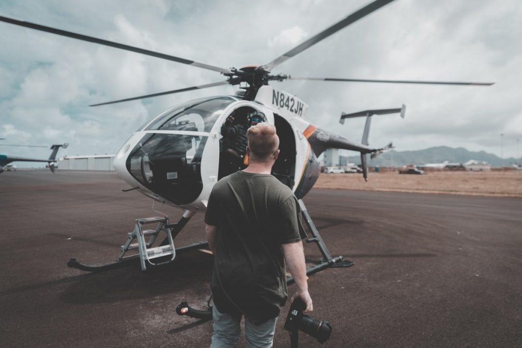 Photographer in front of a helicopter