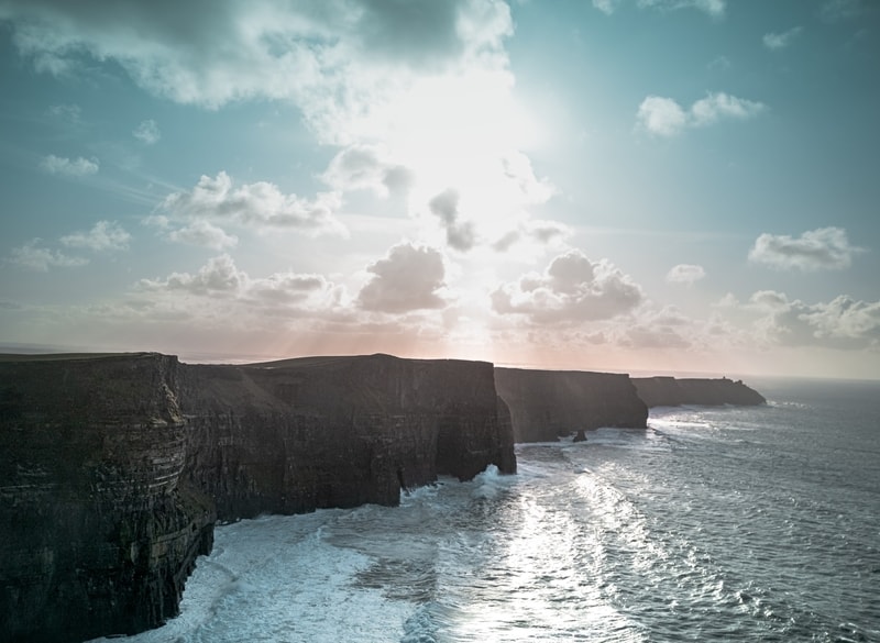 The Cliffs of Moher with the sunny shining in the back
