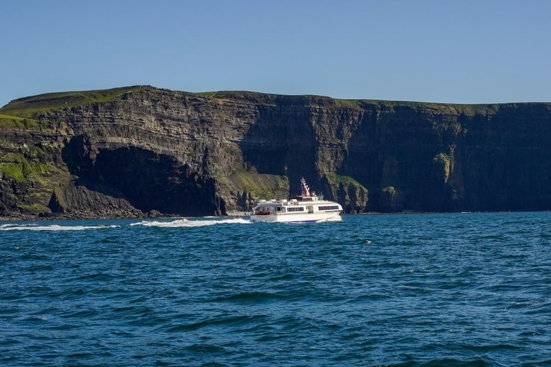 A cruise ship along the base of the Cliffs of Moher