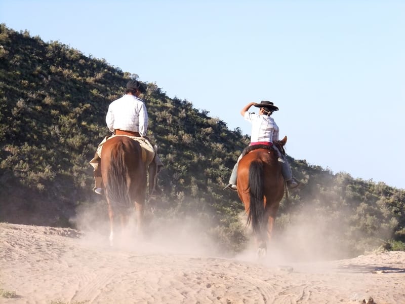 Two people riding a horse in Argentina