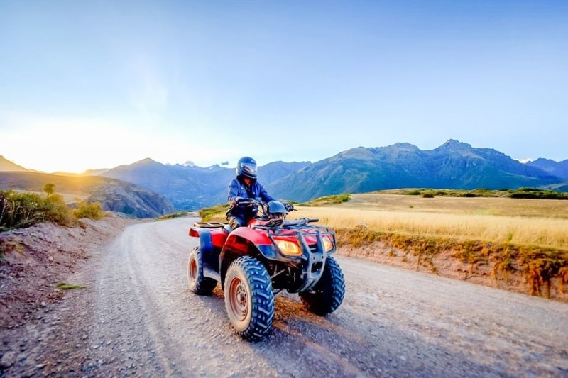 A person riding a quad bike in the sacred valley