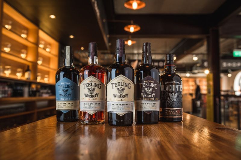 Image of various Teeling Irish Whiskeys on a bar table.