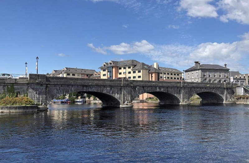 Buildings and bridge next to river in Galway