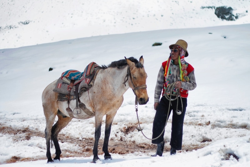 Man with a horse on Rainbow Mountain in Peru