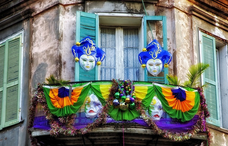 Masks and decorations for Mardi Gras hanging from a balcony in New Orleans