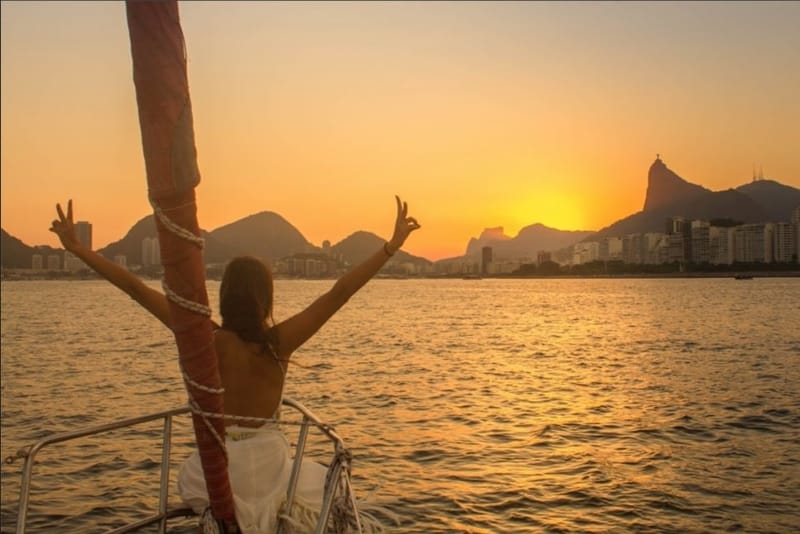 A woman on a boat enjoying the Rio sunset