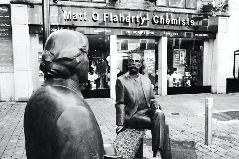Statue of Oscar Wilde in front of chemist in Galway