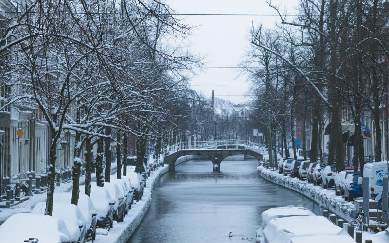 Amsterdam bridge and river in winter during snow
