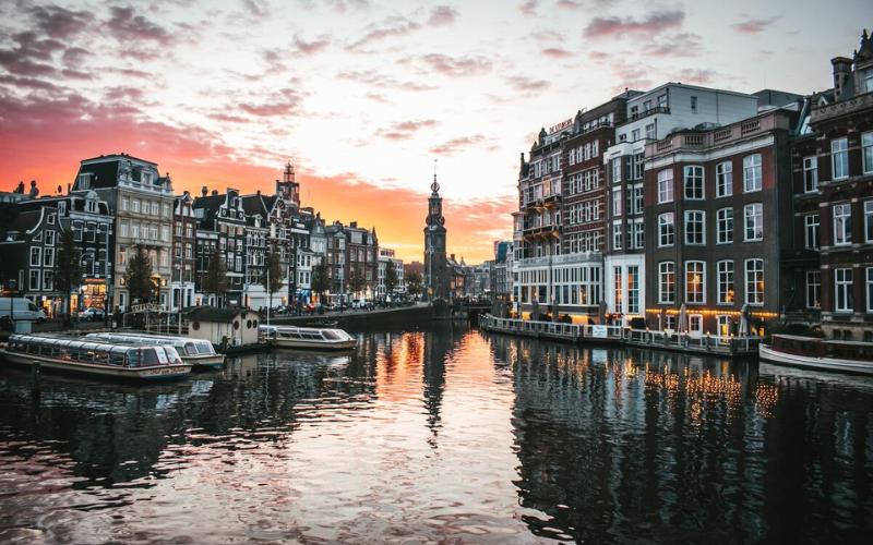 Amsterdam city and river in the Netherlands during a sunset