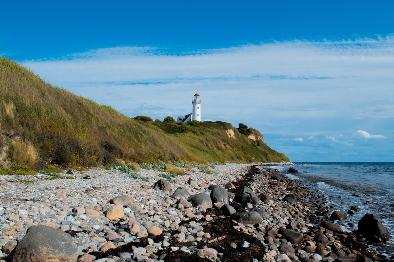 rocky beach with a lighthouse 