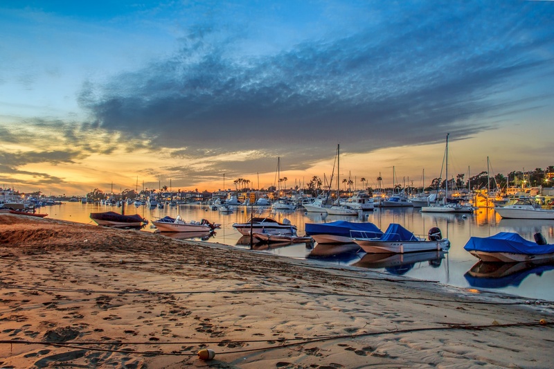 A line of boats docked on the beach at Newport Beach in California