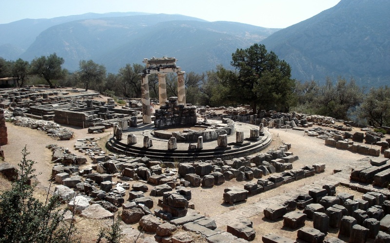 a long shot of the delphi ruins with mountains in the background