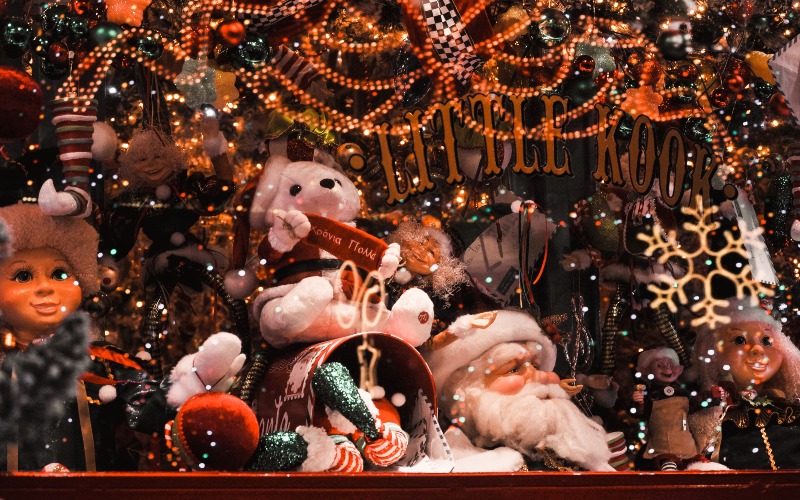 a window with christmas toys and decorations in dim yellow light