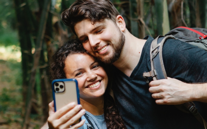 Two tourists taking a selfie and smiling happily