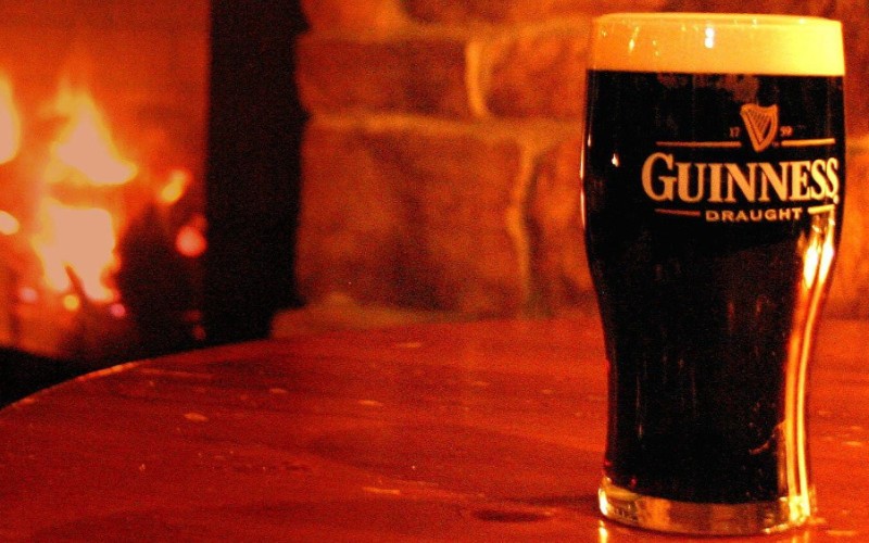 A pint of Guinness sitting on a table.
