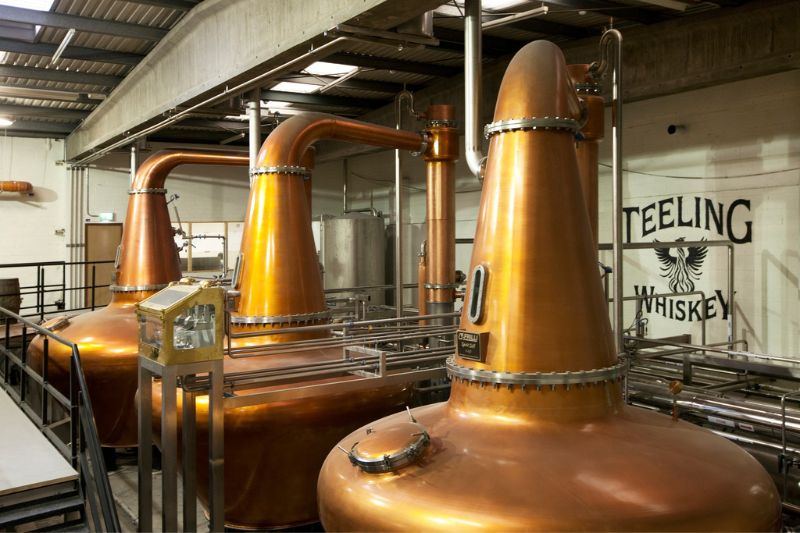 Image of three copper pot stills in the Teeling Whiskey Distillery.