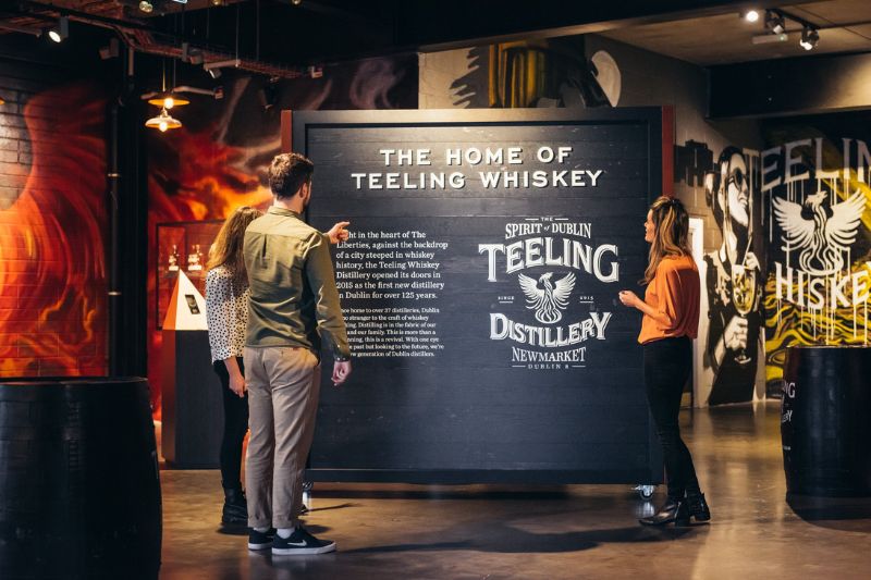 Visitors viewing an exhibition stand saying, "The Home of Teeling Whiskey" in the Exhibition Area.