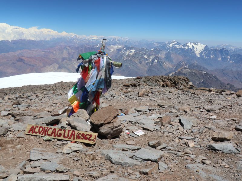 Different flags at one summit on Aconcagua Mountain