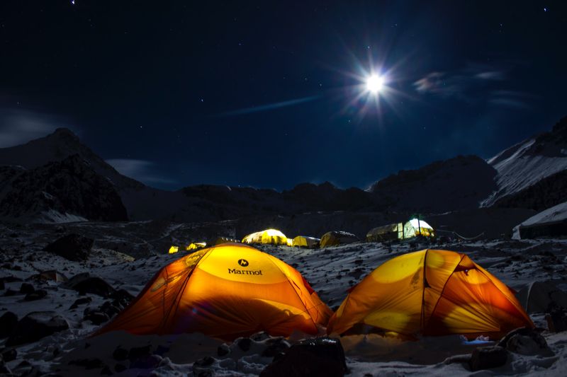 Yellow camping tents on the mountain at night