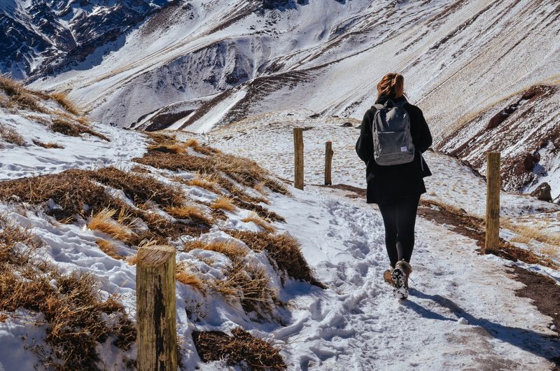 Woman walking on the snowy mountain