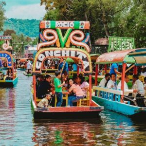 Colorful boats full of tourists and a mariachi band