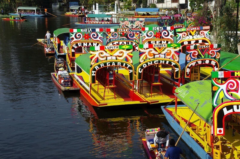 Colorful boats lining the river bank in Mexico